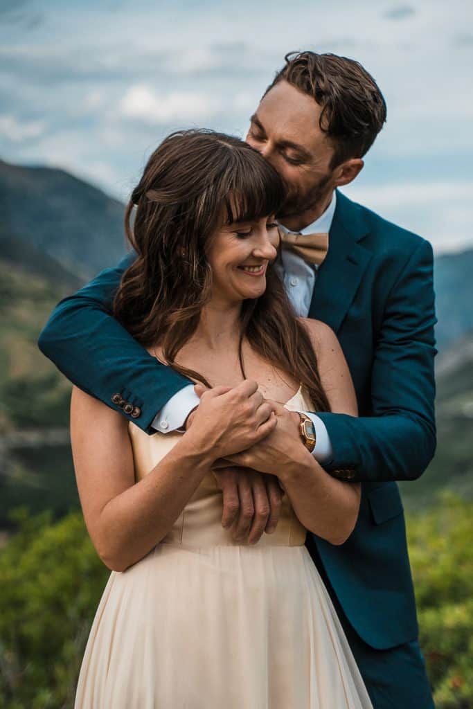 groom embracing bride 