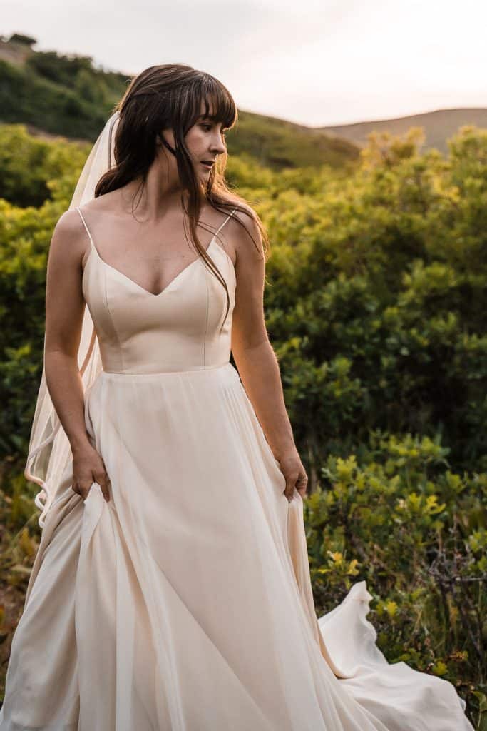 portrait shot of bride in cream colored dress with a view of provo canyon behind her