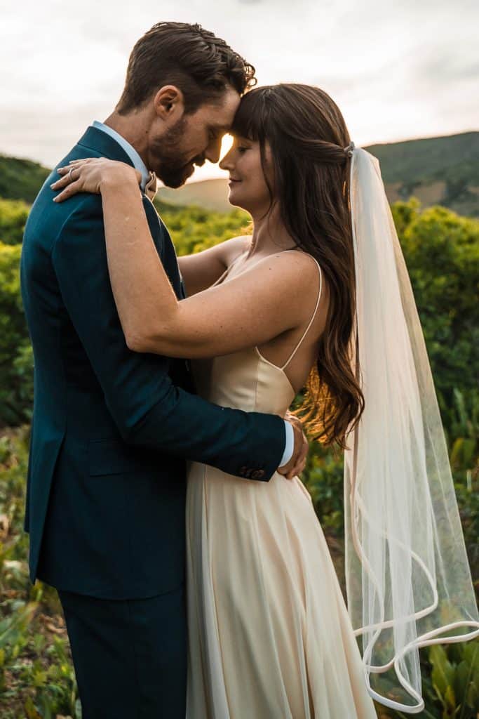 couple facing each other and embracing, veil seen clearly in the shot