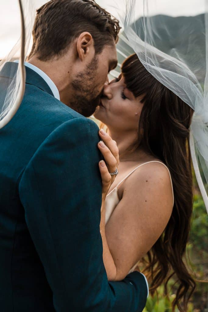 couple kissing under veil