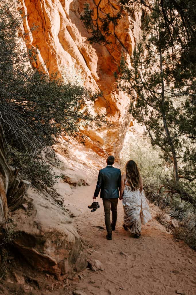 Couple walking on path facing away from camera, this was a hiking wedding elopement