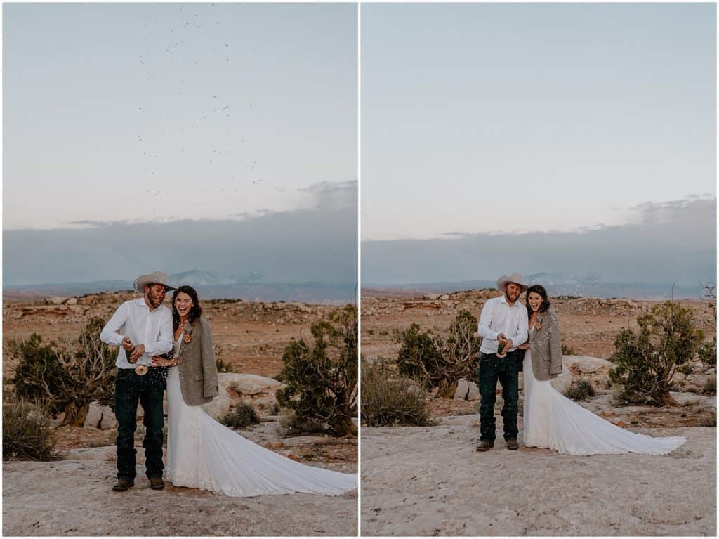 couple popping champagne bottle to celebrate Arches National Park Elopement