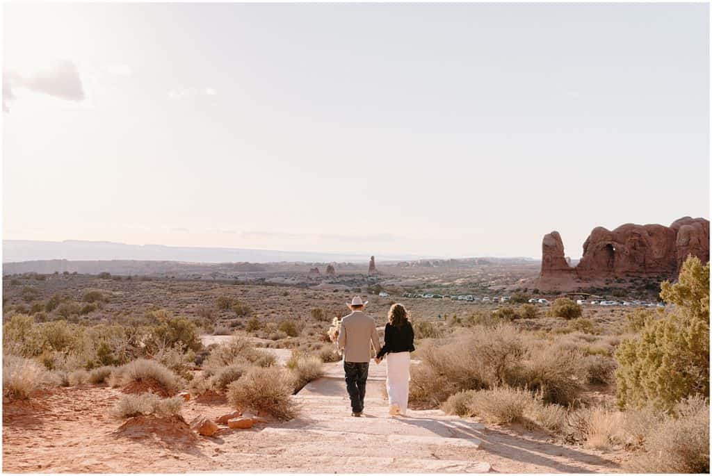 bride and groom walking away from camera in Utah