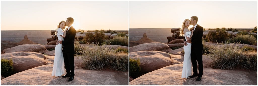 couple smiling at the camera. with the golden sunset in the background, moab elopement day