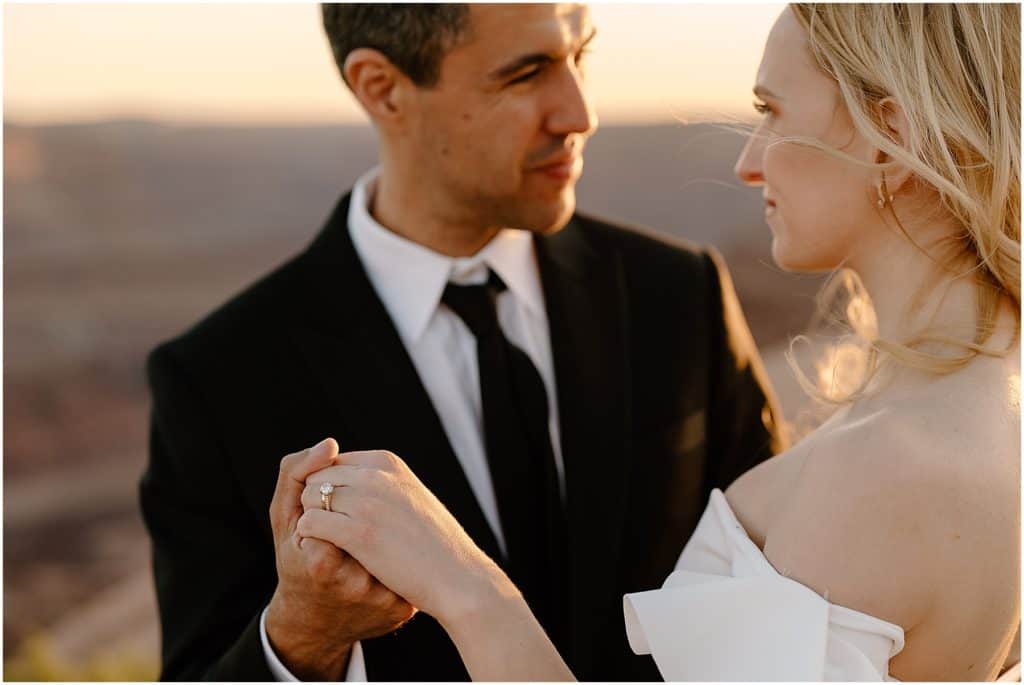 shot of wedding ring. with golden sunset light shining through, moab elopement day for couple