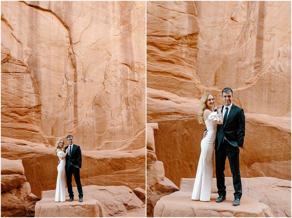  bride and groom in front of canyon rock wall in moab.
