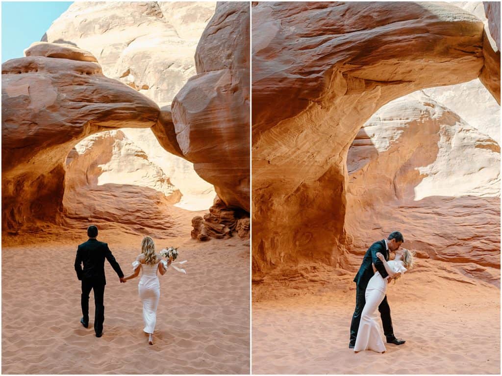couple kissing under arch in their moab elopement.