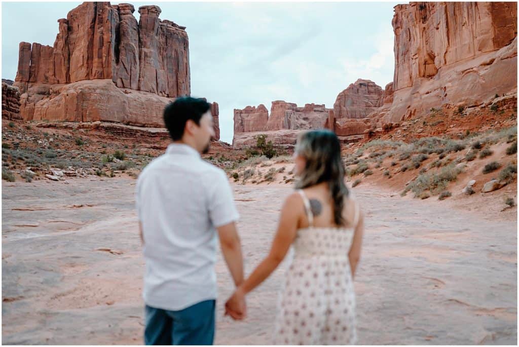 couple seen blurry in the front on their Arches National Park Adventure Session