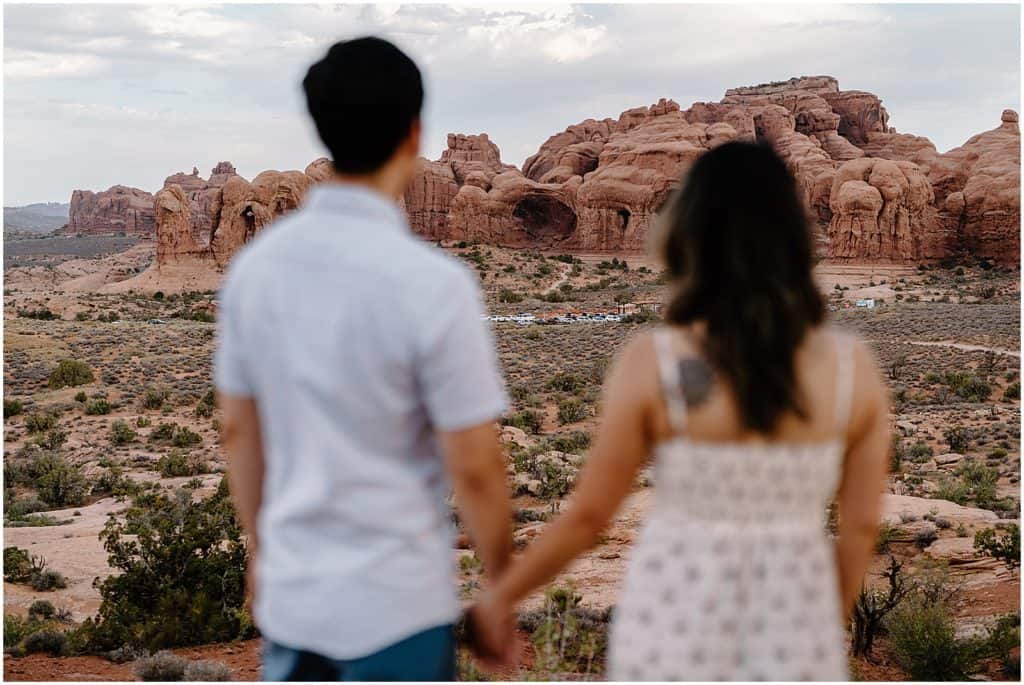 couple seen blurry in the front on their Arches National Park Adventure Session