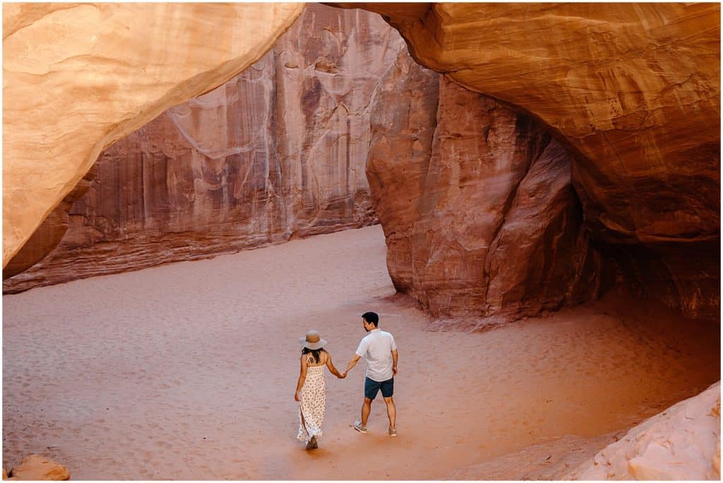 couple under arch in utah