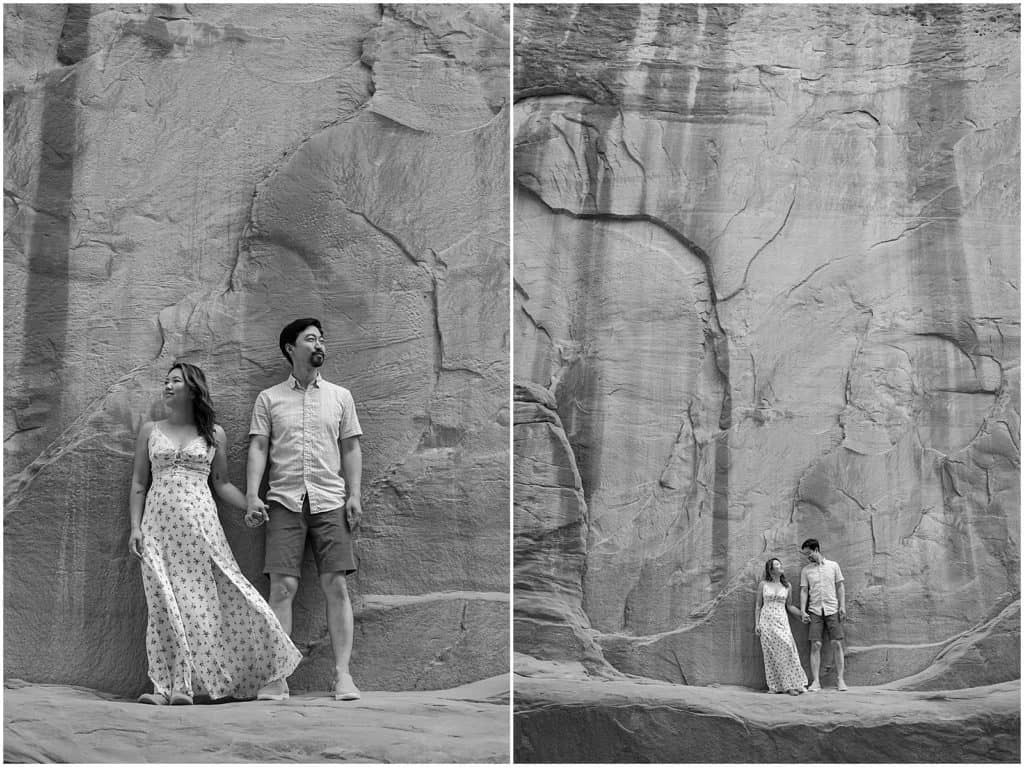 couple in front of rock wall in utah on their adventure session in the arches national park in black and white