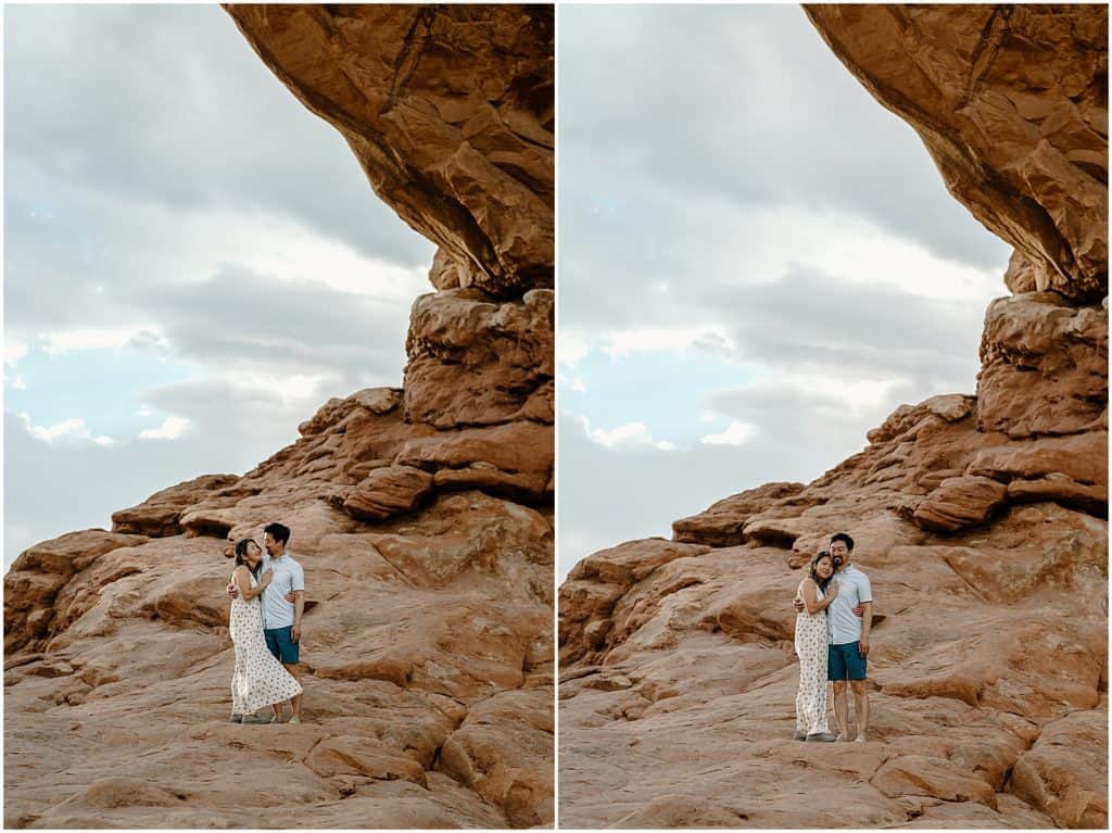 couple under slot canyon in utah on their adventure session in the arches national park