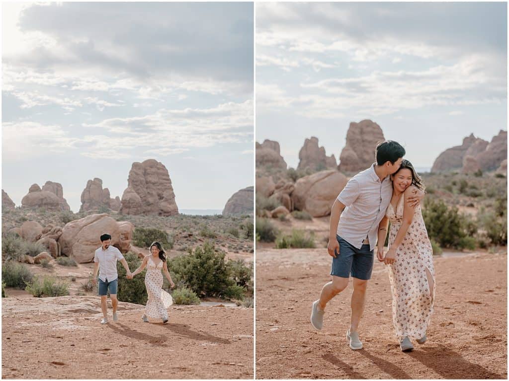 photo of couple holding hands and smiling on their adventure session in the arches national park