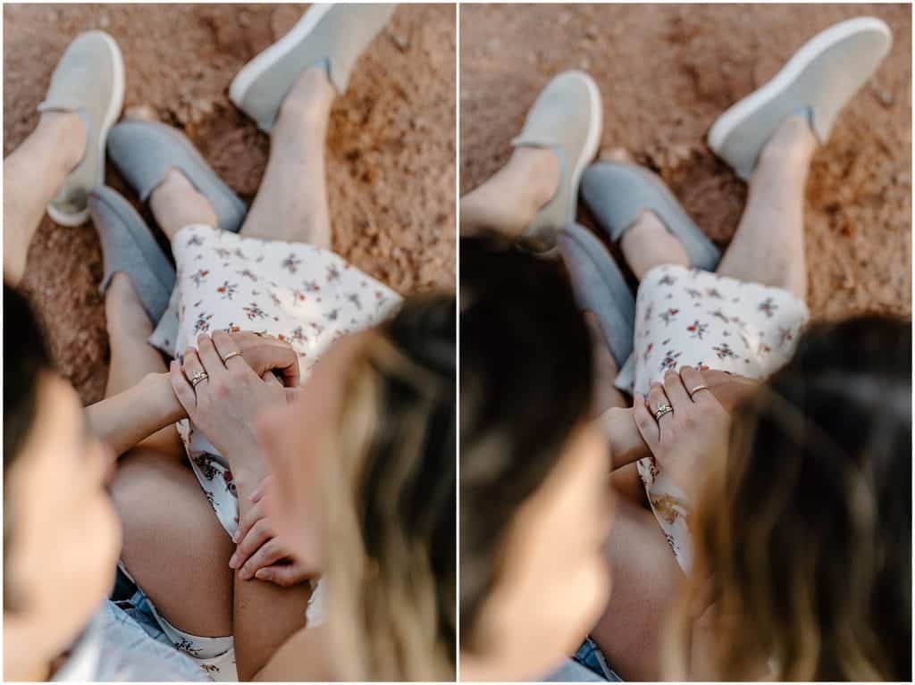 photo of couple sitting on ground and hugging