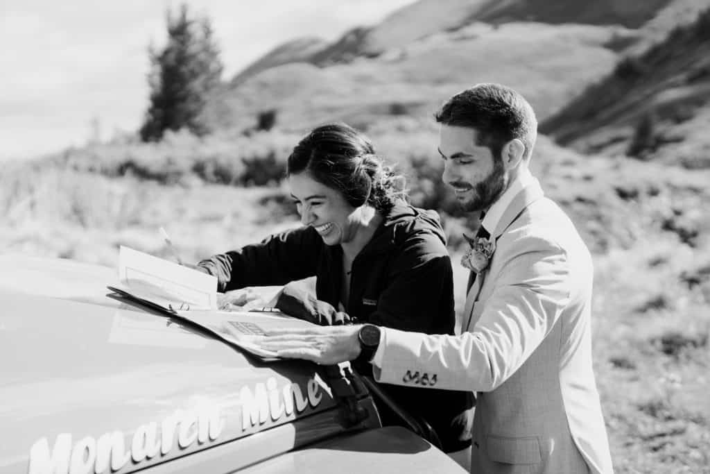 A bride and groom sign their marriage license during their Ouray Colorado elopement ceremony. 