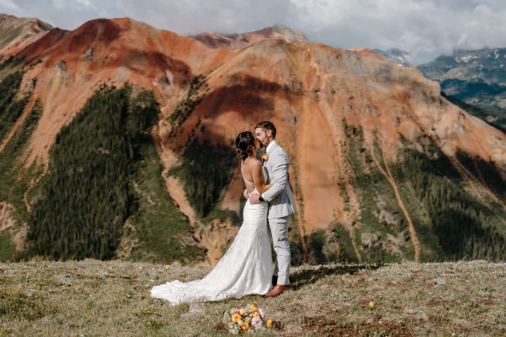 The couple, a bride and groom, hold each other close after finishing their elopement ceremony vows. 