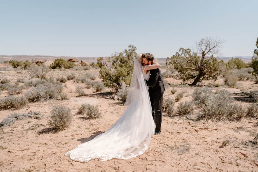 A couple embraces during their Moab elopement first look.