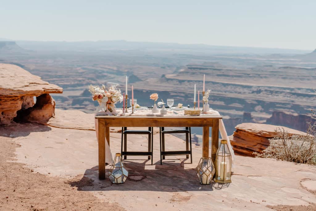 A couple's sweetheart table is all set up overlooking a gorgeous vista in Southern Utah.