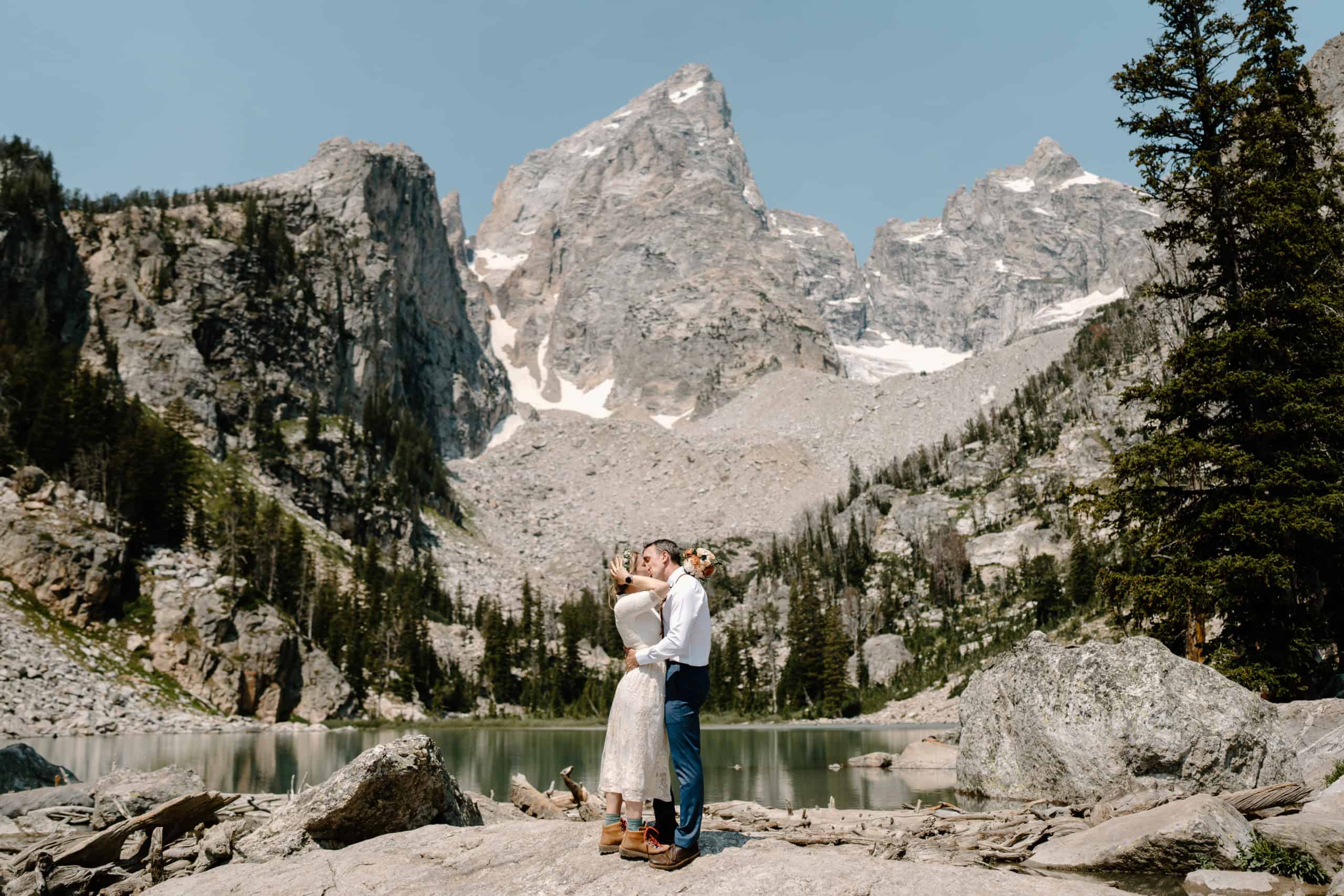 A bride and groom embrace in front of a gorgeous Wyoming landscape for their elopement photos.