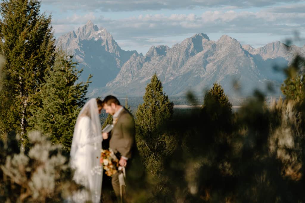 A couple holds each other close during their elopement ceremony as they say their vows in Utah. 