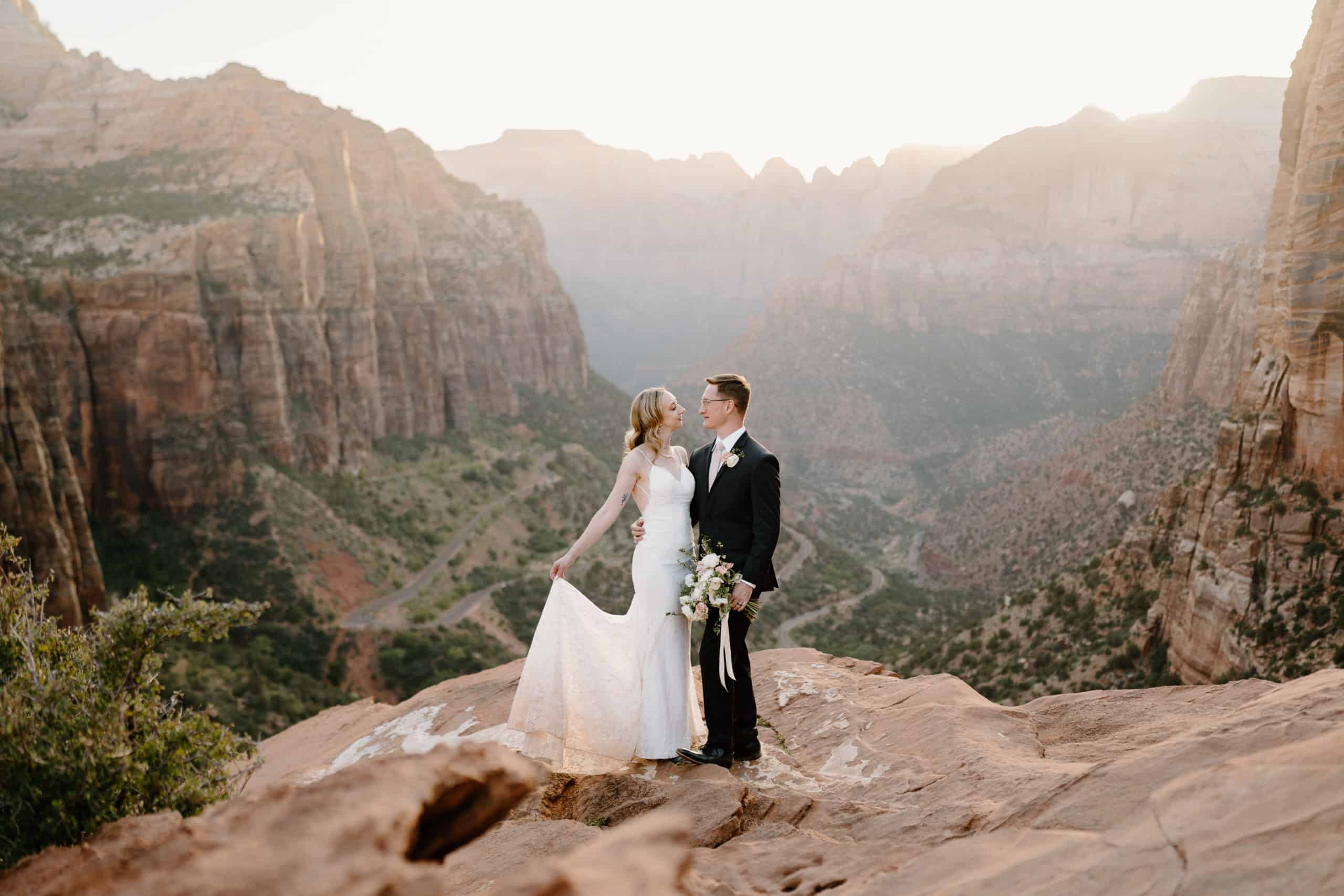 A bride and groom look at each other lovingly during their Zion National Park elopement.