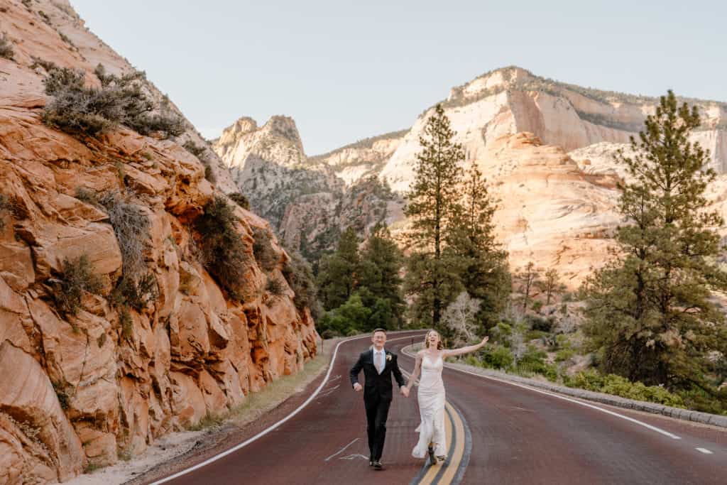 A bride and groom walk down the street in Zion National Park during their southern Utah elopement. 