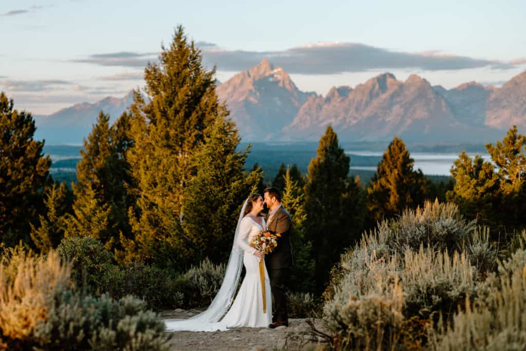 Bailey and John soak in every moment of the sunrise in Jackson, Wyoming, for their Grand Teton National Park elopement. 