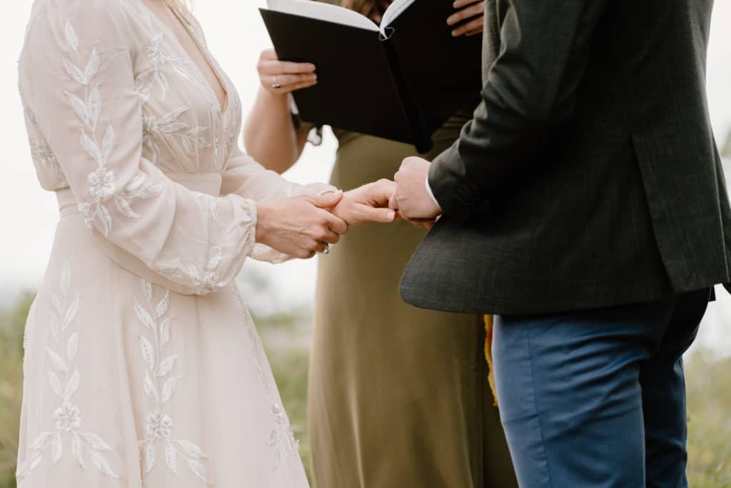 Having an officiant lead your elopement ceremony, like in this image, is a great way to blend traditional and non-traditional elements.