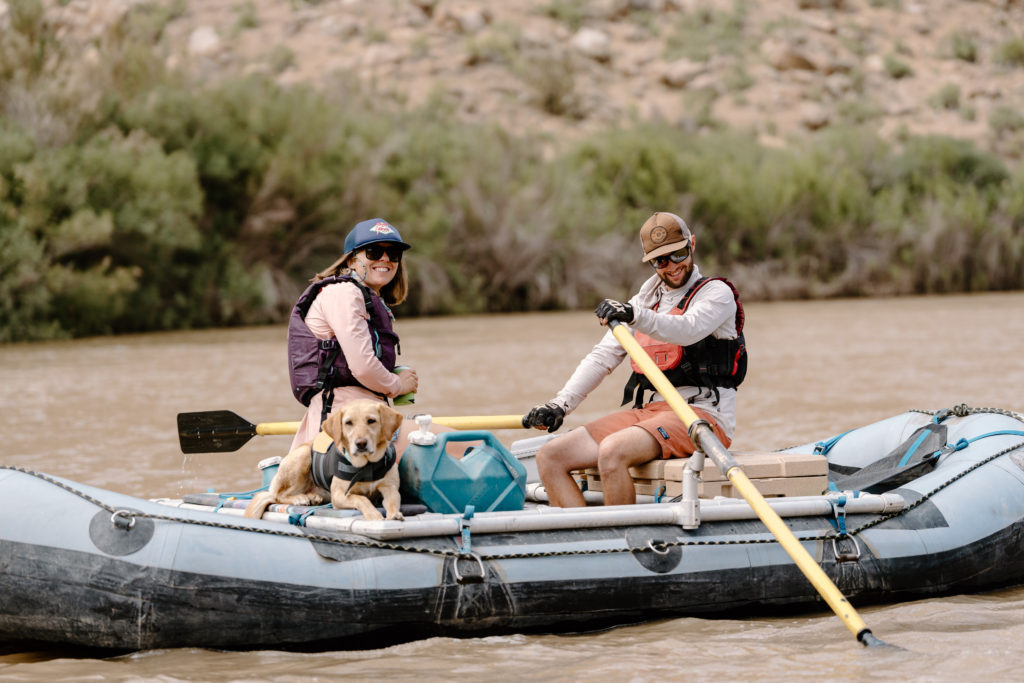 A bride, groom, and their dog raft down the Green River on their elopement day. 