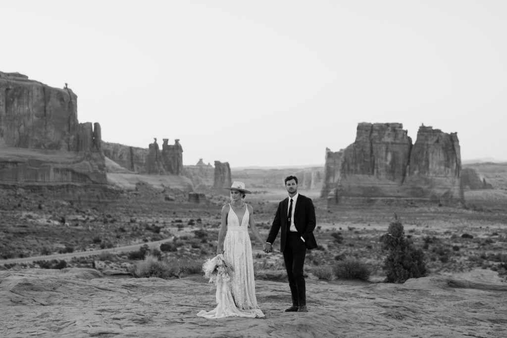 A bride and groom celebrate their elopement in Arches National Park. 
