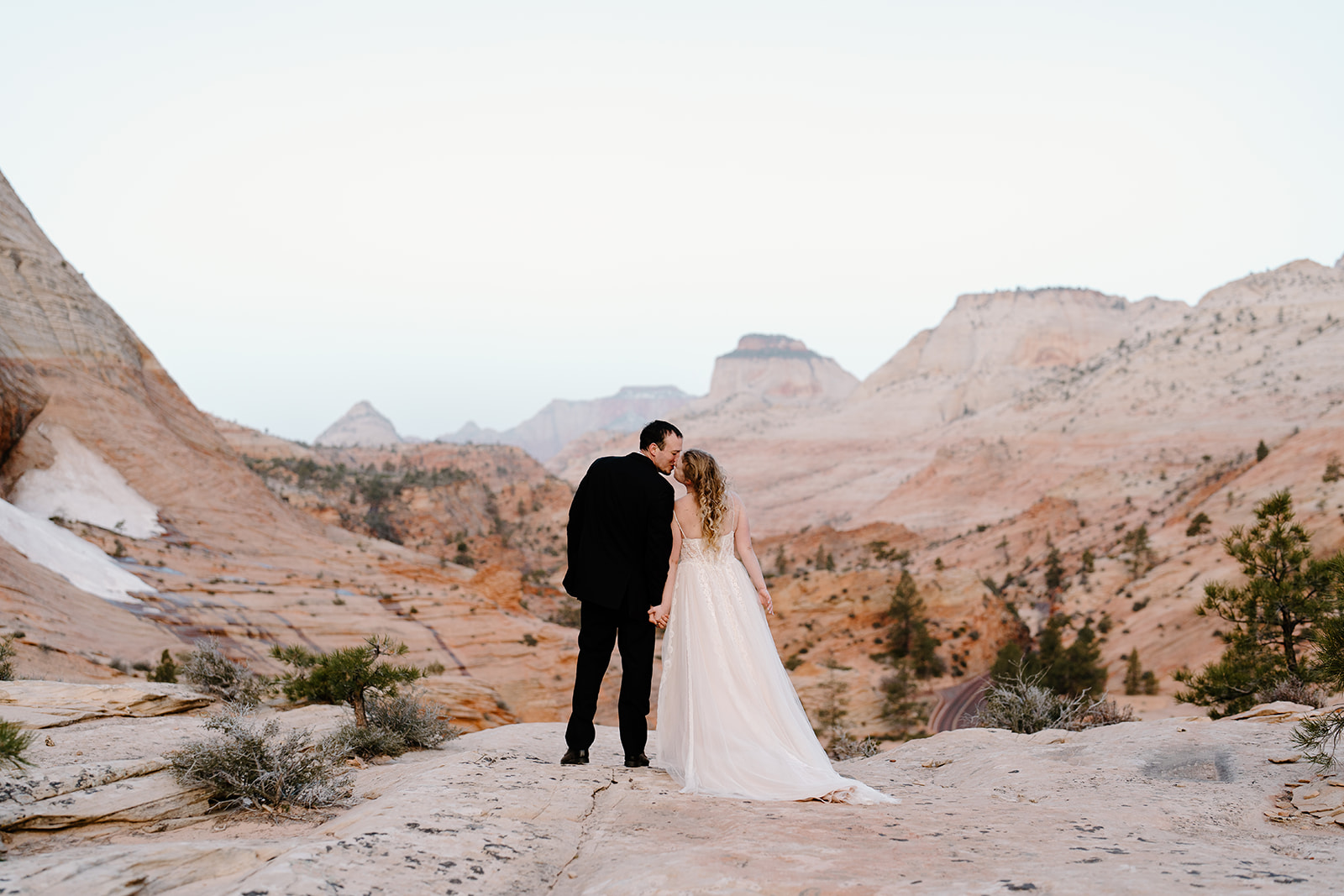 A couple kisses eachother after their adventure elopement in Southern Utah, a day they experienced and enjoyed fully.
