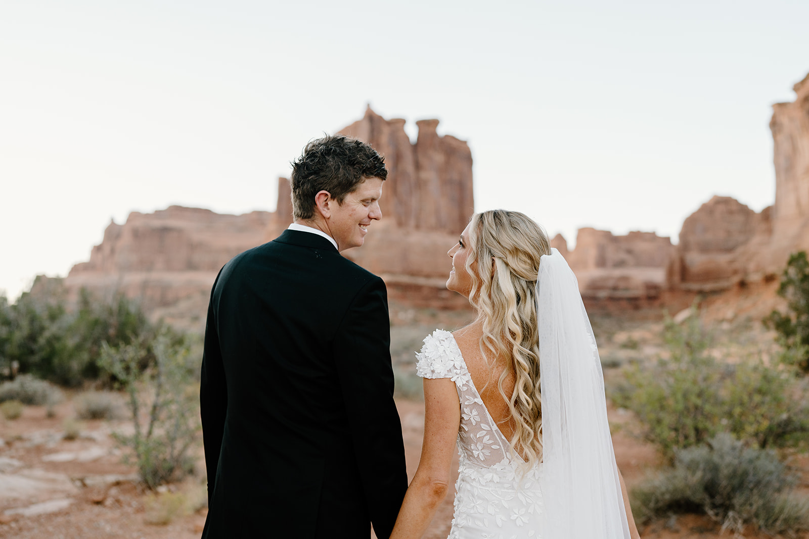 A bride and groom look at each other longingly during their Moab adventure wedding.