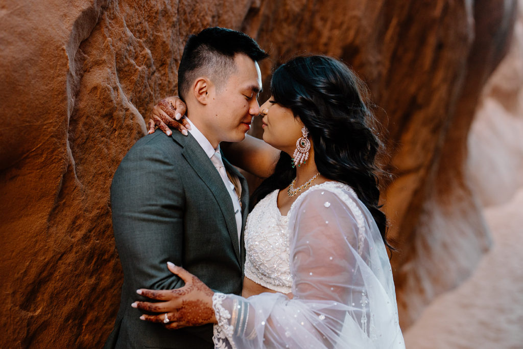 A bride and groom soak in a moment at Arches National Park without worrying about the time because of their two-day elopement package.