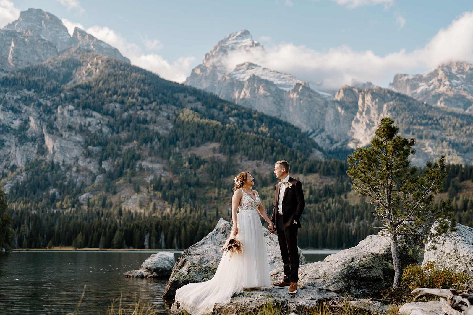 A bride and groom take a moment to enjoy the Grand Tetons during their two-day elopement package.