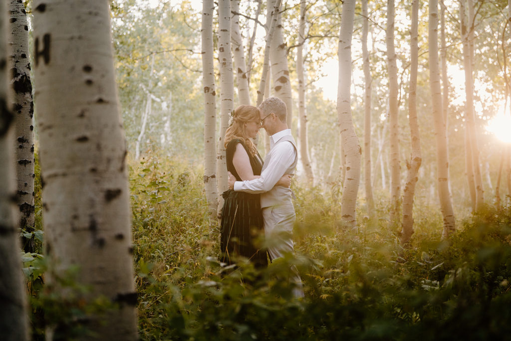 A husband and wife hug in a Salt Lake City forest.