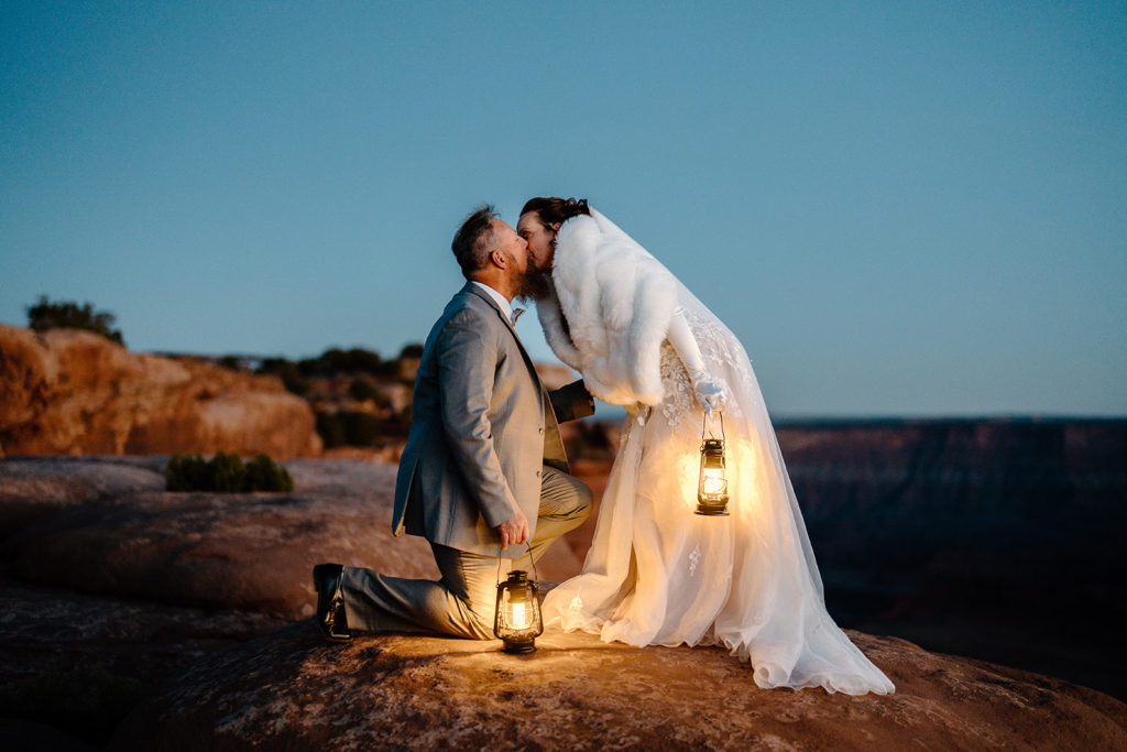 A bride and groom explore Moab by the light of lanterns as part of their all-day elopement. 