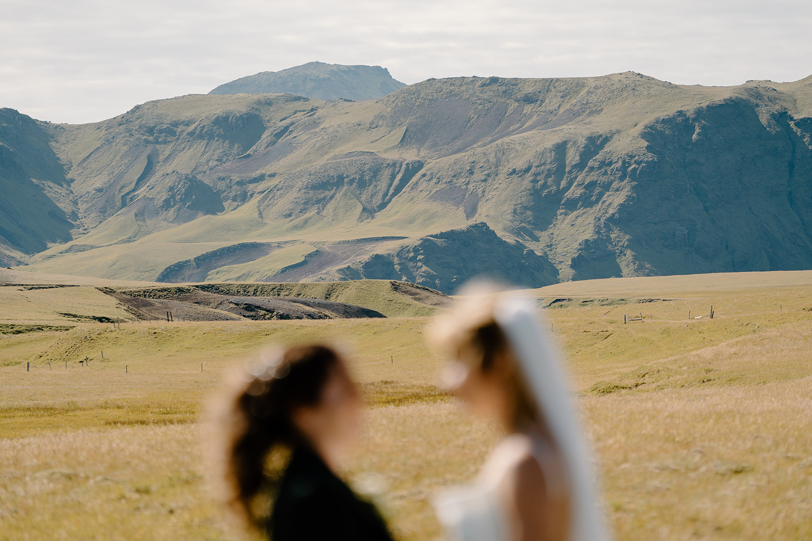 Two brides lean in close to each other during their two-day elopement.
